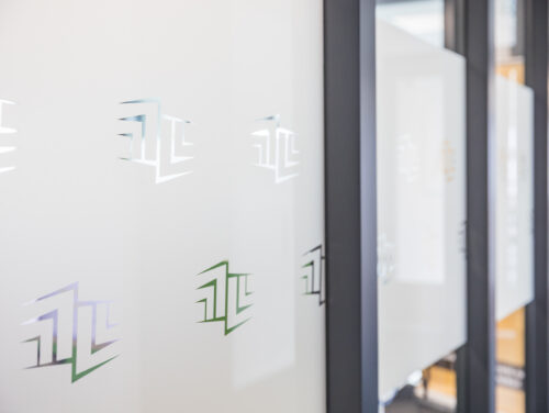 Glazen kantoorwand met MOCTB-logo’s
